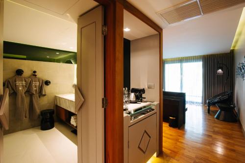 a kitchen with a sink and a stove top oven at Cross Chiang Mai Riverside in Chiang Mai