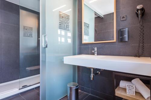 a bathroom with a sink, toilet and shower stall at Andante Hotel in Barcelona