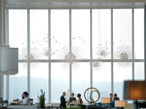 a group of people in an office with a large window at Osaka Marriott Miyako Hotel in Osaka