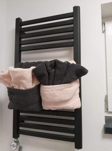 a pile of towels sitting on top of a chair at Le DiamanSter Francorchamps in Stavelot