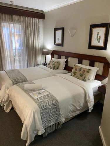 Ένα ή περισσότερα κρεβάτια σε δωμάτιο στο Oxford Lodge Vryheid
