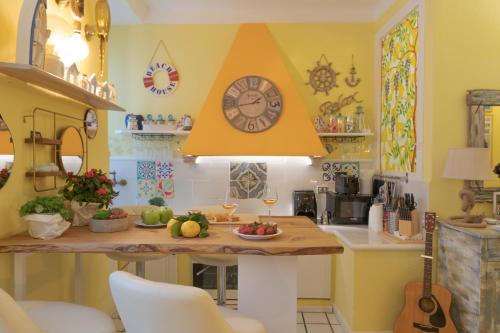 a kitchen with a table with a clock on the wall at Noah Home in Manarola