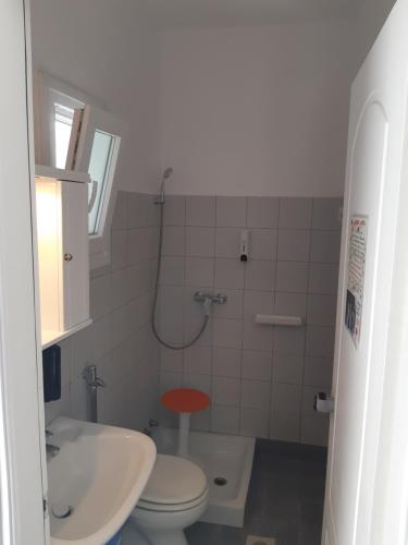 a small bathroom with a toilet and a sink at Pagali Hotel in Órmos Aiyialís