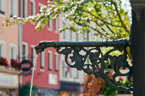 a stream of water coming out of a metal fence at Ferienwohnung historisches Teisendorf in Teisendorf