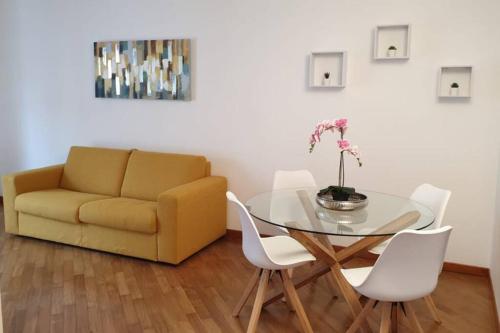 a living room with a table and a couch at Casa Riccò di Cinzia e Samuele in Riccò del Golfo di Spezia