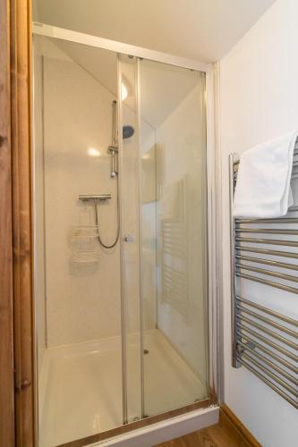 a shower with a glass door in a bathroom at Cambrian View in Aberystwyth