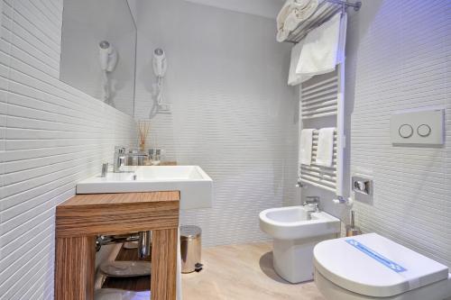 a bathroom with a sink and a toilet at Hotel Monte Rosa in Chiavari