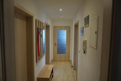 a hallway with a bench and a door to a hallway with the ocean at Am Sachsenstein - Zum Skispringer in Lauter