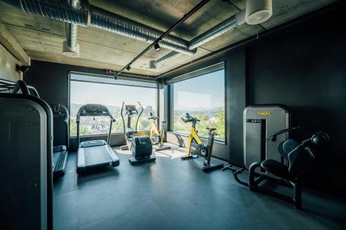 a gym with cardio equipment and a large window at Comfort Hotel Porsgrunn in Porsgrunn