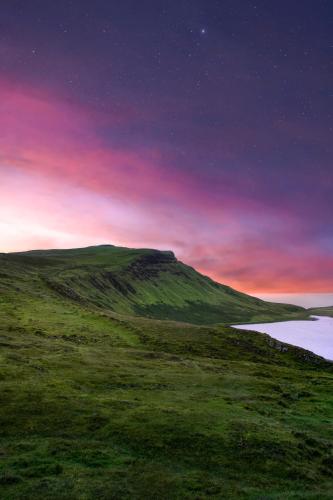 a hillside with a lake under a night sky at Isle of Skye Guest House in Kyleakin
