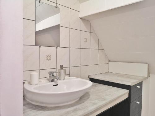 a white bathroom with a sink and a mirror at ✪ Le Convivial ✪ Duplex Alsacien ✪ PARKING ✪ RBNB✪ in Turckheim