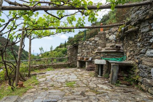 a stone wall with two benches in front of it at Villa Smith in Vernazza