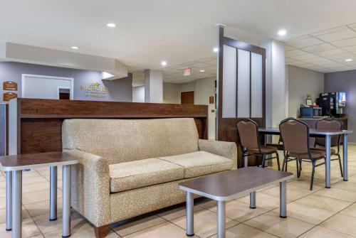 a waiting room with a couch and tables at Microtel Inn & Suites Dillsboro/Sylva in Dillsboro