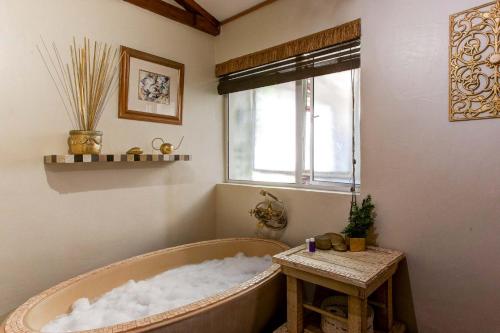a bathroom with a bath tub covered in snow at Strand Honeymoon Suite Studio in Cape Town