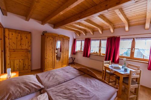 a bedroom with a large bed and a table at Schwarzwaldliebe in Fröhnd