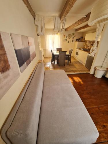 a large couch in a living room with a table at Seabed Apartma 1 in Piran