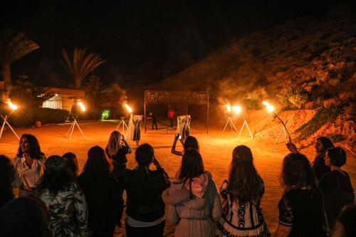 a group of people watching a performance at night at Hotel Dakhla Club & SPA in Dakhla