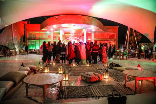a group of people standing in a room with lights at Hotel Dakhla Club & SPA in Dakhla
