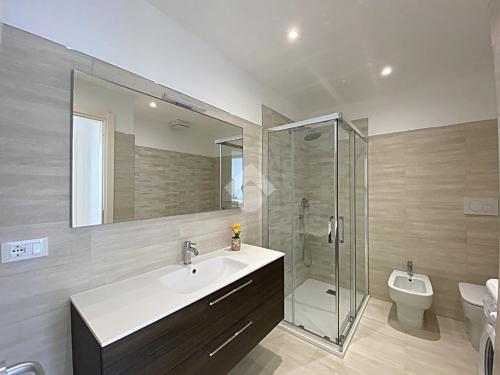 a bathroom with a sink and a shower and a toilet at residence cristallo in Alassio