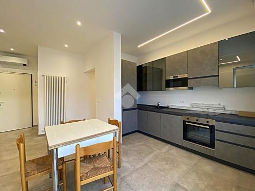 a kitchen and dining room with a table and chairs at residence cristallo in Alassio