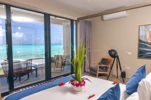 a living room with a view of the ocean at Villa Bluu Zanzibar in Jambiani