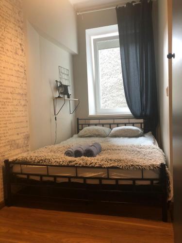 a bedroom with a bed with a window at Dmowskiego blisko Rynku in Wałbrzych