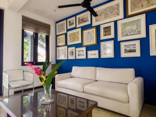 a living room with a white couch and a blue wall at Parangi Weligama Bay - Thema Collection in Weligama