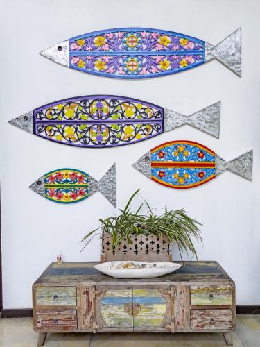a wall with paintings of fish on it at Parangi Weligama Bay - Thema Collection in Weligama