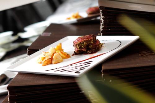 a plate with a piece of cake on a table at Boutique Hotel Calzavecchio in Casalecchio di Reno