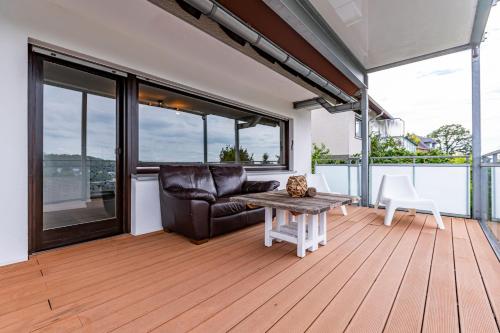 a living room with a couch and a table at Architektenwohnungen mit Panoramablick bei Köln in Lindlar