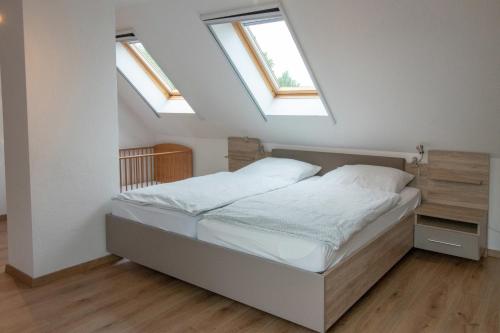 a bedroom with a bed with skylights at Huxfeld-Hof - Wümme in Grasberg