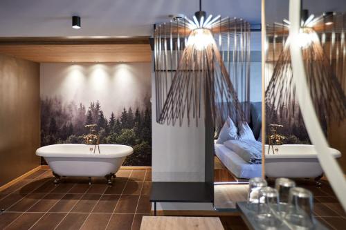 a bathroom with two sinks and a bath tub at EdeR FriDa - Tuttiii KomPletti ALL inKlusiv in Maria Alm am Steinernen Meer