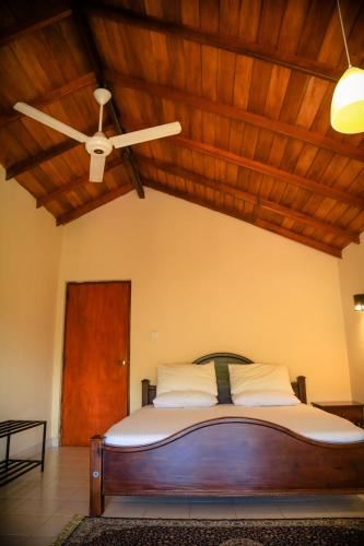 a bedroom with a bed with a ceiling fan at Freedom Lodge, Kandy in Kandy