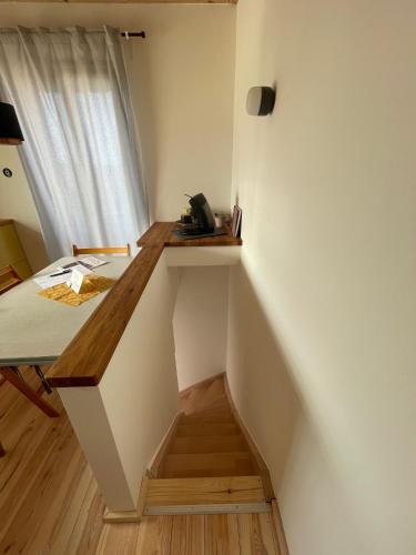 a staircase in a room with a bed and a window at Ferienturm zur ehemal. Umspannstation Poppenroth in Bad Kissingen