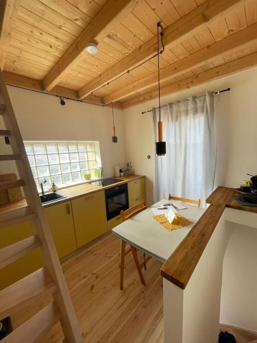 a kitchen with a table and a dining room at Ferienturm zur ehemal. Umspannstation Poppenroth in Bad Kissingen