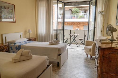 a hotel room with two beds and a balcony at Via Sparano Suite in Bari