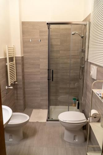 a bathroom with a shower and a toilet and a sink at Via Sparano Suite in Bari
