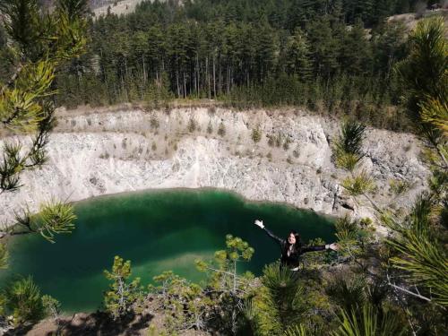 a person standing in front of a body of water at Vila ZLATARSKA PAHULJA in Nova Varoš