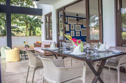 a dining room with a table and chairs at Parangi Weligama Bay - Thema Collection in Weligama