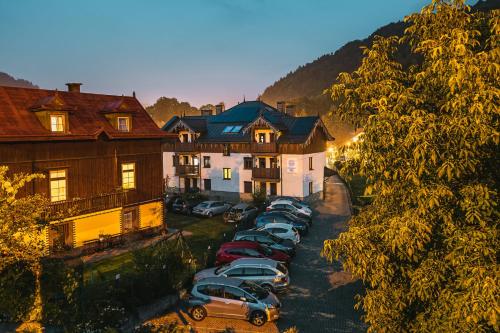 a row of cars parked in a parking lot next to houses at Apartamenty Eko in Szczawnica