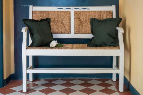 a bench with two pillows on it in a room at Haus Gerd Janssen Wohnung 1 in Spiekeroog