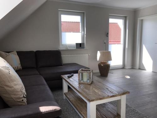 a living room with a couch and a coffee table at Schleiglück in Rieseby