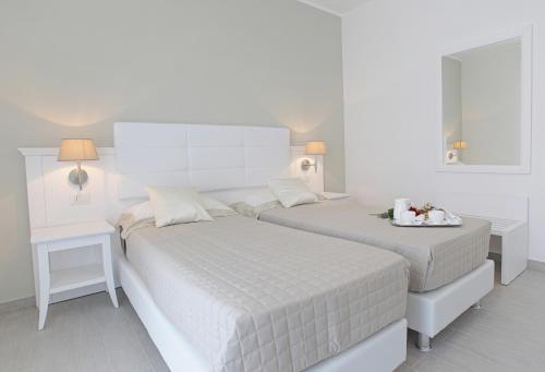 A bed or beds in a room at Scala Dei Turchi Resort
