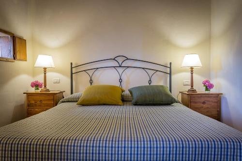 a bedroom with a bed with two pillows on it at Villa S.Andrea in San Casciano in Val di Pesa