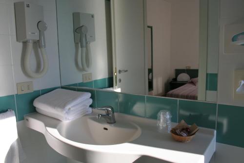 a bathroom with a sink and a mirror at Hotel Bel Tramonto in Marciana