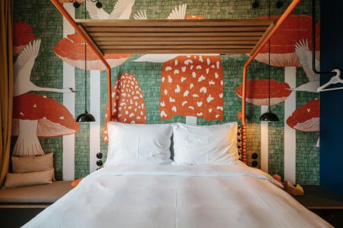 a bedroom with a bed and a wall with mushrooms at Superbude Wien Prater in Vienna