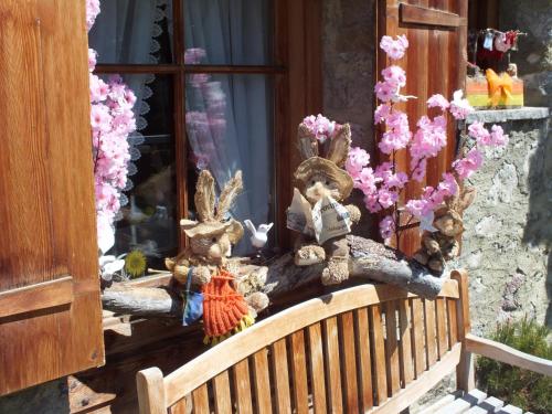 a wooden bench sitting in front of a window at Baita Luleta in Livigno