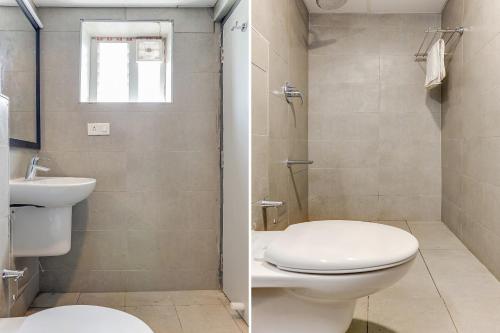 a bathroom with a toilet and a sink at UPAR Hotels Uthandi, ECR in Chennai
