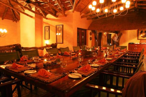 a large long wooden table in a room with chairs at Lalibela Game Reserve Lentaba Safari Lodge in Paterson