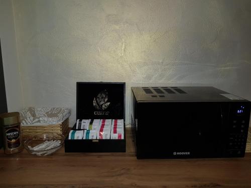 a box of books sitting next to a microwave at Happy Inn Hotel Alpiyskiy in Saint Petersburg